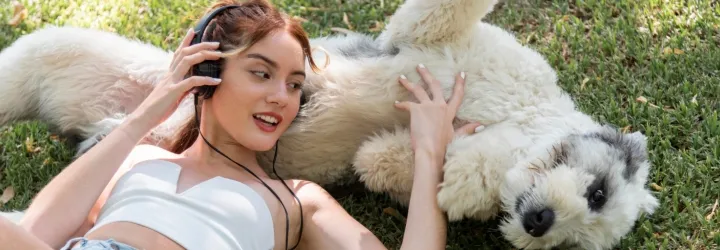 Pretty girl and a dog rolling in poo