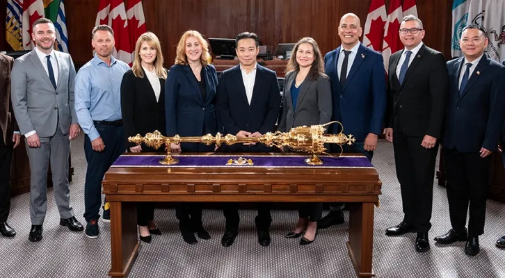 Vanpoover city officials looking smug and posing next to a big golden dog toy